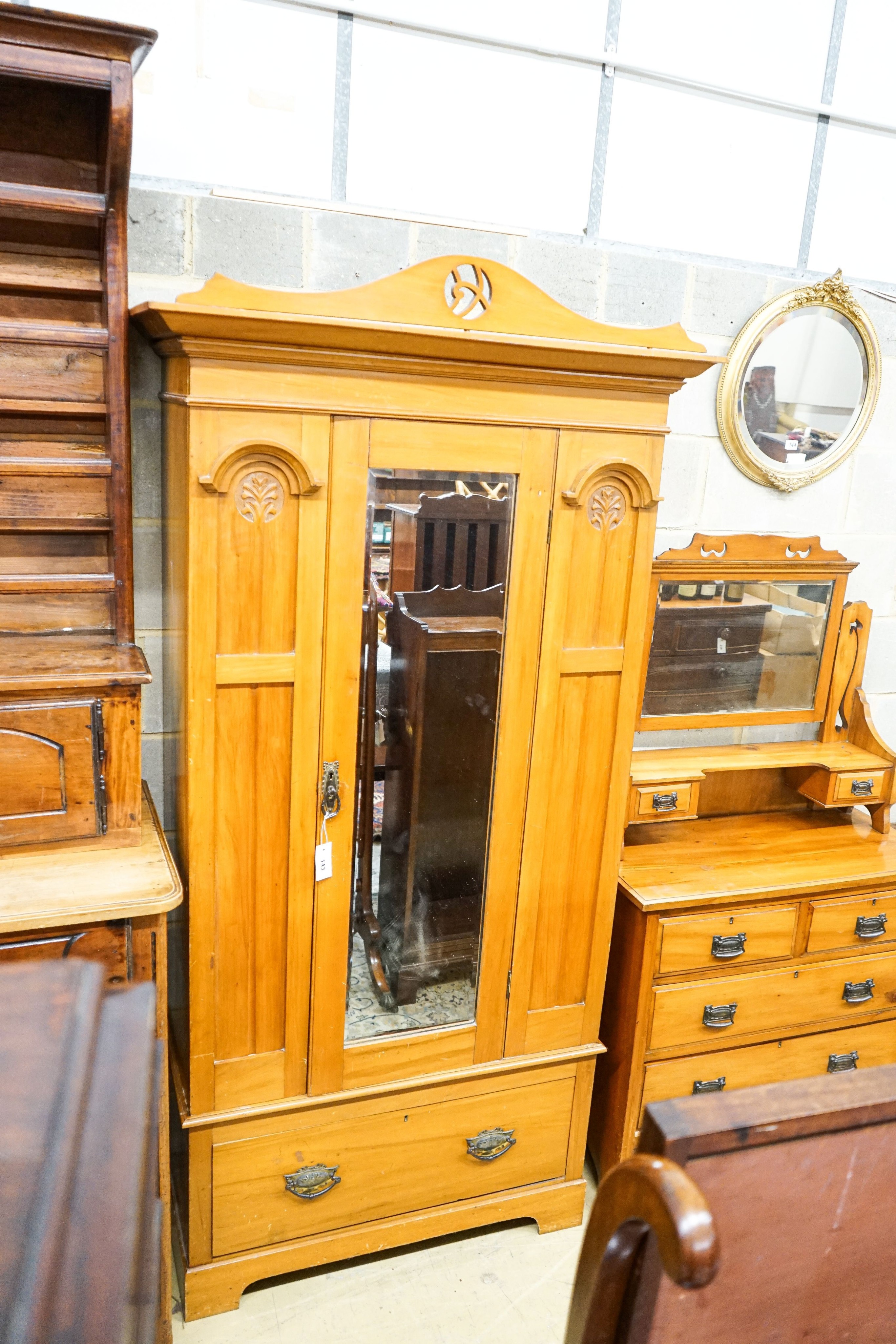 A late Victorian satin walnut mirrored wardrobe, length 105cm, depth 48cm, height 210cm and a dressing table